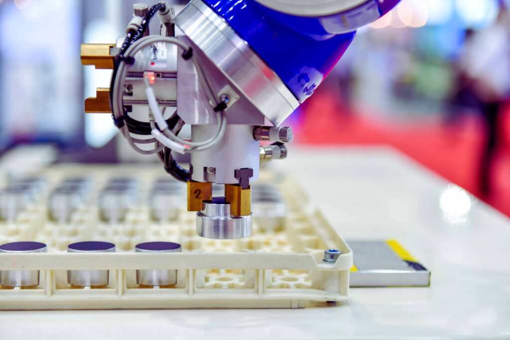 a robotic hand picking a component