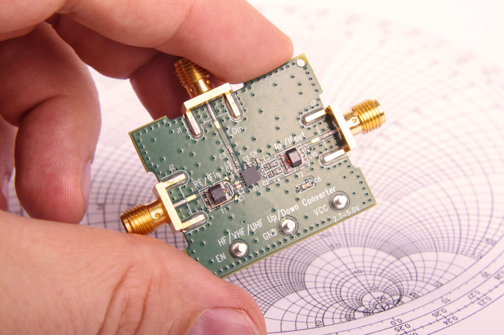 RF engineer inspects a PCB